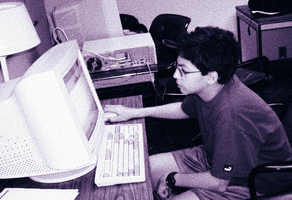 Kid using a computer in the early 2000s